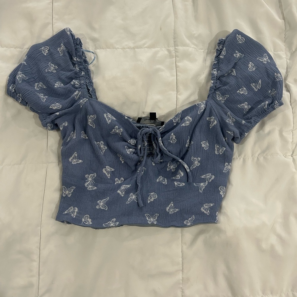 Light blue top with butterflies